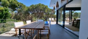 a wooden table and chairs on the balcony of a house at Casa Blanca in L'Escala
