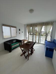 a living room with a table and a couch at Útulný apartmán na Praia de Chaves, Boa Vista in Sal Rei