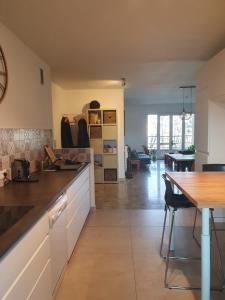 a kitchen with a table and a dining room at Magnifique Appartement en ville in Aix-en-Provence