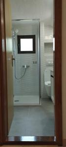 a glass shower in a bathroom with a toilet at Apartment Yadi in Korčula
