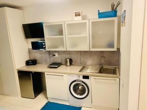 a kitchen with a sink and a washing machine at SOLARE in Bibione