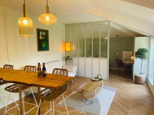 Una sala de estar con una mesa y sillas de madera. en Appartement Chèvremont Metz, en Metz