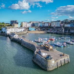 an aerial view of a harbor with boats in the water at Canol Y Bryn - 3 Bedroom Holiday Home - Tenby in Tenby