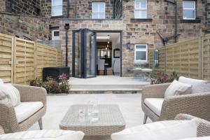 a patio with chairs and a table in front of a building at Townhouse by Harrogate Serviced Apartments in Harrogate