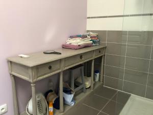 a small table in a bathroom with a shower at Barbazan comminges in Barbazan