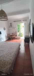 a bedroom with a bed and a living room with a table at Villa féeric in Toulon