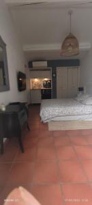 a bedroom with a bed and a table in it at Villa féeric in Toulon