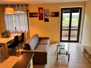 a living room with a couch and a table at Casa degli Orti in Bra