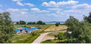 a group of houses in a field with a road at u Kapitana in Rowy