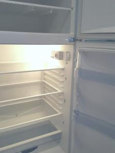 an empty refrigerator with its door open and its shelves at Rooms Kata in Rovinj