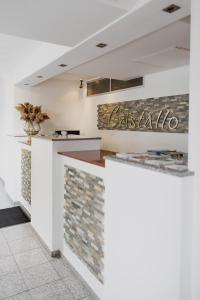 a restaurant with white walls and stone counter tops at Hotel Cristallo in Landshut