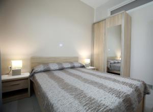 a bedroom with a large bed and a mirror at Pavlidis in Siviri