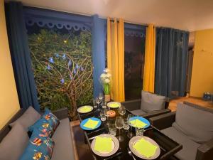 a living room with a table with glasses on it at Studio COEUR DE VILLAGE - ORIENT BAY in Orient Bay