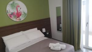 a bedroom with a bed with two towels on it at Casa di Monique 1 in Bari Palese