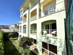an apartment building with chairs and a yard at Three bedroom apartment, PRIME Javea location in Jávea