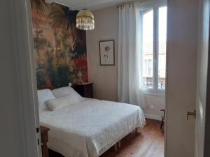 een slaapkamer met een bed en een groot raam bij Casa azul & blanca in Banyuls-sur-Mer