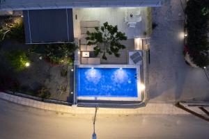 an overhead view of a swimming pool at night at Thomas House Hersonissos - Private Pool - Sleeps 6 in Hersonissos