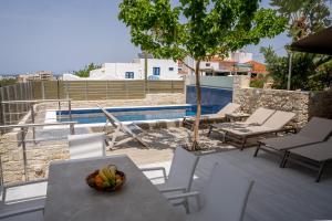 a bowl of fruit on a table on a patio at Thomas House Hersonissos - Private Pool - Sleeps 6 in Hersonissos +31 photos