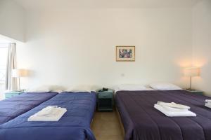 Postel nebo postele na pokoji v ubytování Axiothea Hotel