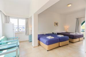 Postel nebo postele na pokoji v ubytování Axiothea Hotel