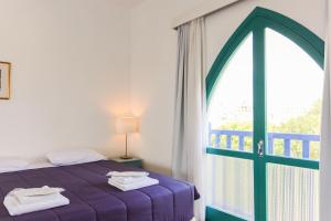 Postel nebo postele na pokoji v ubytování Axiothea Hotel