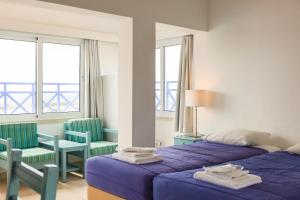 Postel nebo postele na pokoji v ubytování Axiothea Hotel