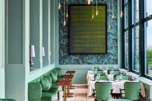 a dining room with white tables and green chairs at Château Gütsch in Luzern +37 photos