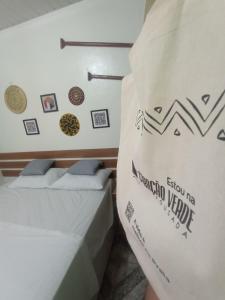 En eller flere senge i et værelse på Pousada Coração Verde