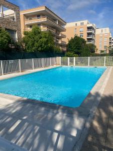 a large blue swimming pool in front of a building at Juan les pins in Antibes