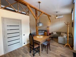 a kitchen and living room with a table and a couch at Karlsons Holiday in Liepāja