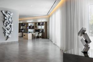 a living room with a table and a large window at AC Hotel by Marriott San Juan Condado in San Juan