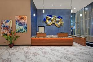 a hotel lobby with a mask on the wall at Residence Inn by Marriott New Orleans French Quarter Area/Cen B in New Orleans