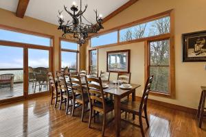 a dining room with a table and chairs and windows at Bella Vista in Beech Mountain