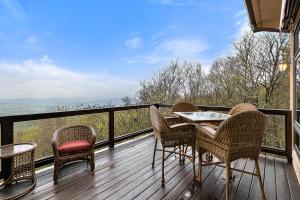 a balcony with chairs and a table on a deck at Bella Vista in Beech Mountain