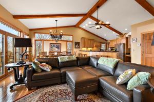 a living room with a leather couch and a kitchen at Bella Vista in Beech Mountain
