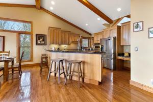 a kitchen with wooden cabinets and a table and chairs at Bella Vista in Beech Mountain +26 photos