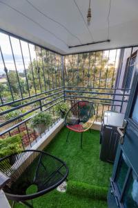 a balcony with two chairs and green grass at Nairobi Countryside Gem -ILRI in Nairobi