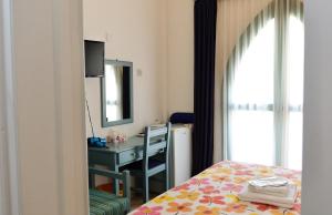 Postel nebo postele na pokoji v ubytování Axiothea Hotel