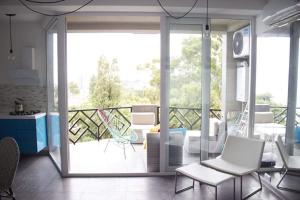a living room with a view of a balcony at Beach blue in Kvariati
