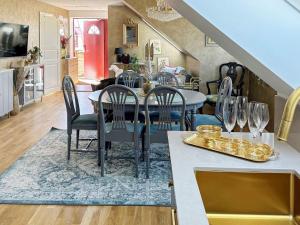 a dining room and kitchen with a table and chairs at Holiday home HELSINGBORG in Helsingborg