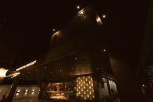 a night view of a building with lights on it at Hotel Millennium Inn, Prayagraj in Allahābād