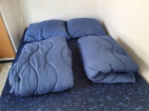 - un lit avec des oreillers bleus au sol dans l'établissement CS 61 - Vakantiepark Callassande, à Callantsoog