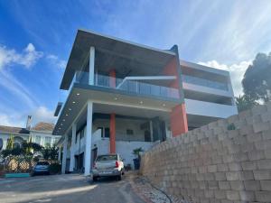 a car parked in front of a house at Amazing! 7 bedroom villa with rooftop pool & views in Cape Town