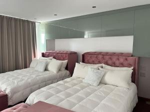 a bedroom with two beds and a large mirror at Amazing! 7 bedroom villa with rooftop pool & views in Cape Town +20 photos