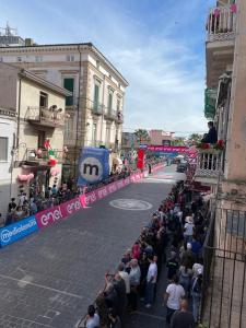 a crowd of people standing on the side of a street at La finestra sul corso in Ortona