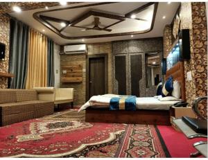 a bedroom with a bed and a living room at Hotel Al-Zahoor In, Srinagar in Srinagar