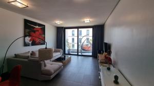 a living room with a couch and a tv at Anfa Place in Casablanca