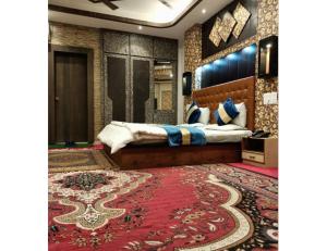a bedroom with a bed and a red rug at Hotel Al-Zahoor In, Srinagar in Srinagar