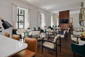 a restaurant with tables and chairs and a tv at Tbilisi Marriott Hotel in Tbilisi City