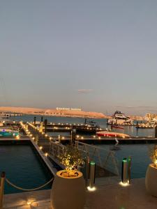 a view of a harbor at night with lights at Marrassi Marina spacious chalet in El Alamein